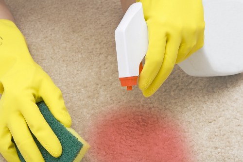 Cleaner tidying a modern flat in Barnes with a flexible local service