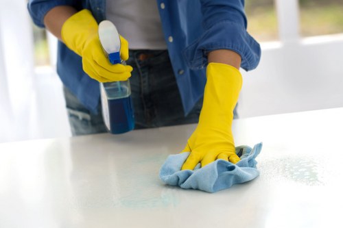 Commercial office cleaning tasks in a Barnes workspace including desks and floors
